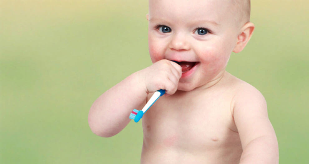 A baby with a toothbrush.